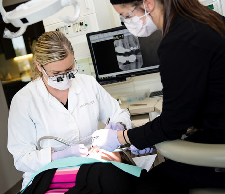 LIGHTING THE WAY: Dr. Sarah Palmer and a staffer craft another beautiful smile