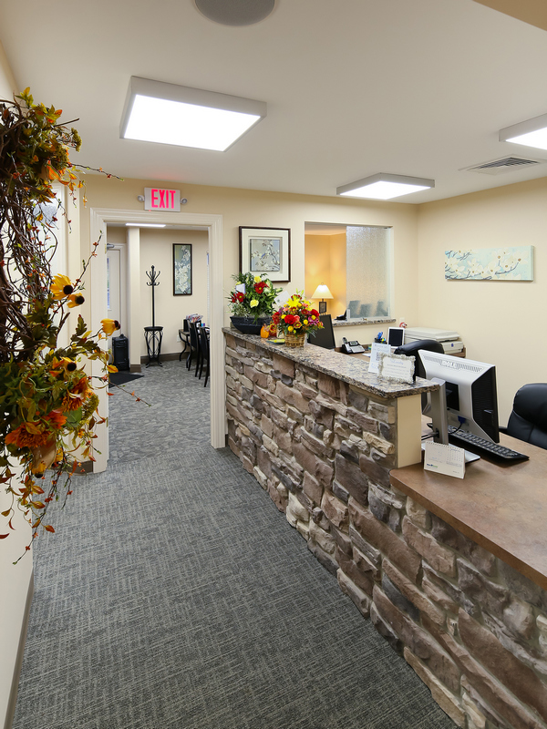 MUCHBRINGING THE OUTSIDE IN: Landry Family Dentistry’s rough-hewn reception area; (below) the practice’s sleek exterior