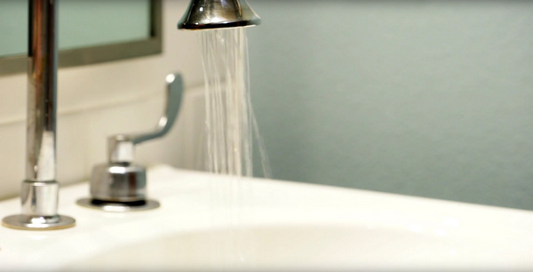 RIGHTEOUS FLOW: Efficient faucets and toilets save the practice 16,500 gallons a year; (top) a friendly reminder to be cognizant of water waste.