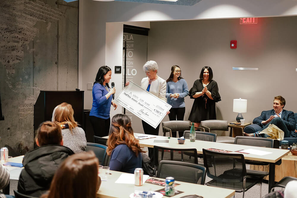CHECK, PLEASE: Dr. Parsons receiving a donation for her foundation