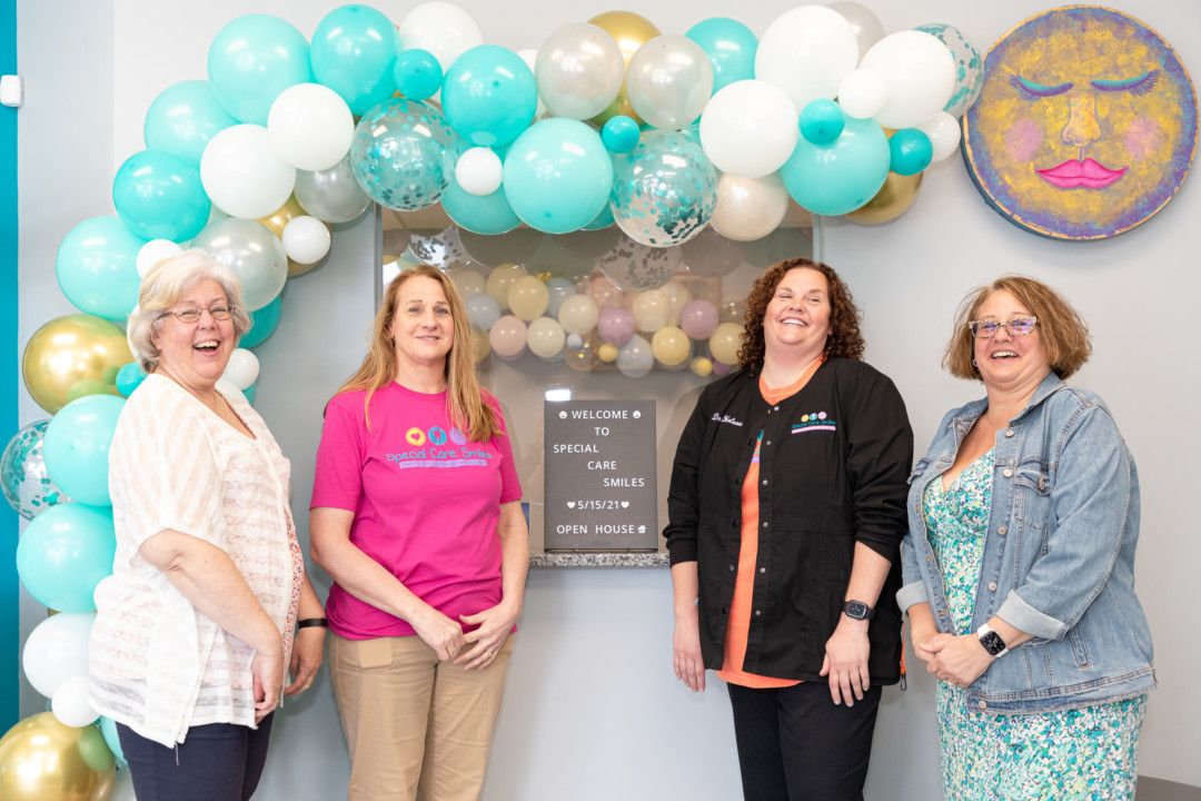 Dr. Laura Holena with her family at the Special Care Smiles Open House event on May 15: sister-in-law Sand'e Holena, sister Karen Dillon, and sister Denise Onderko.