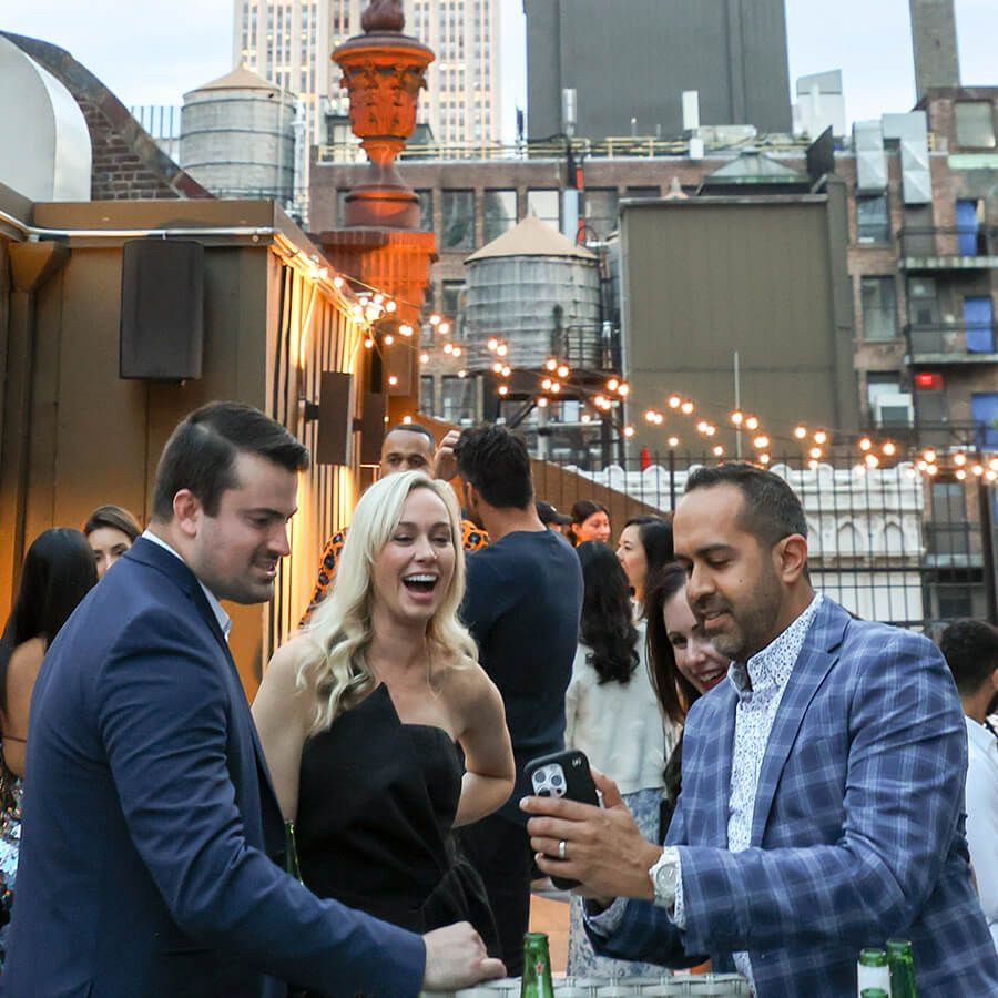Dr. Michelle Ament (center) and Dr. Samir Singh (right) with their spouses, Jared Putnam and Suzanne Singh, in the shadow of the Empire State Building as evening descends