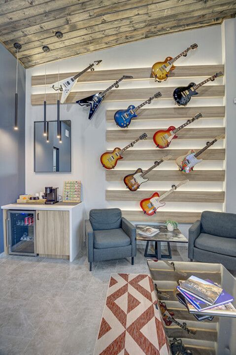 Imperfect 10: The reception room wall gives a noble second life to castoffs from Dr. Callia’s extensive guitar collection. “I chose guitars that look cool but I’m not crazy about their playability.”