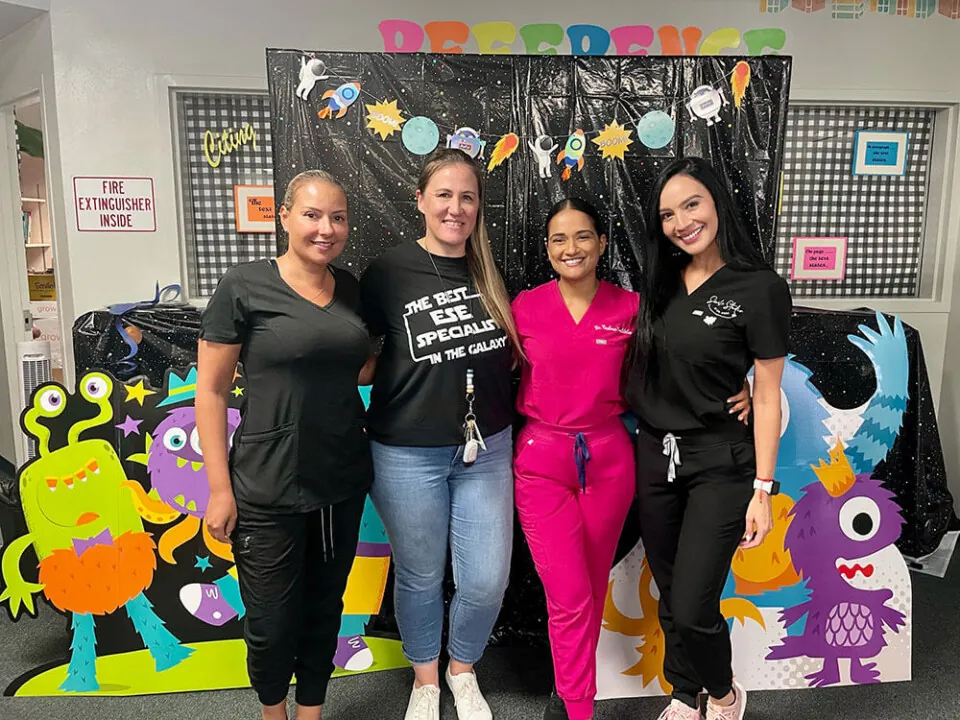 GOOD NEIGHBORS: Smile Studio staff, including Dr. Reshma Baddaloo (second from right) and Rivera (far right) at a teacher appreciation event in the practice’s South Florida community. 