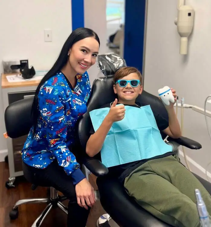 HER “WHY”: With her son, Santiago, during an office visit a few years ago—a reminder of the support, sacrifice and drive that have fueled her journey in dentistry. 