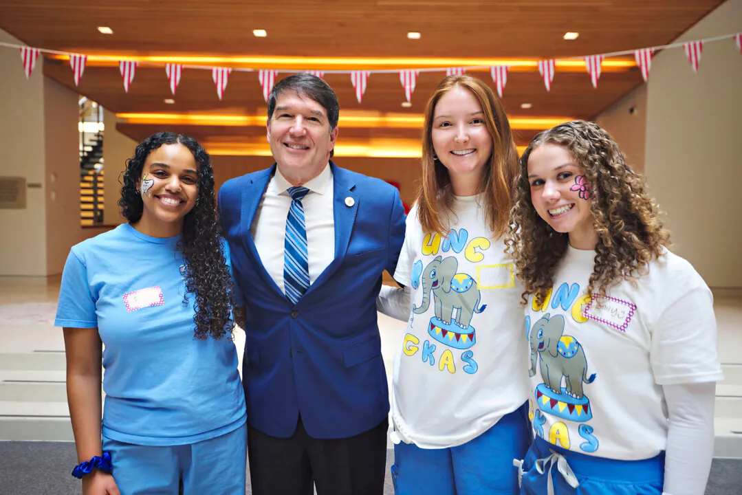 Dr. Hyman with (from left) students Didi Mesfin, Halle Earnhardt and Emily Baker during UNC’s Give a Kid a Smile Day. 