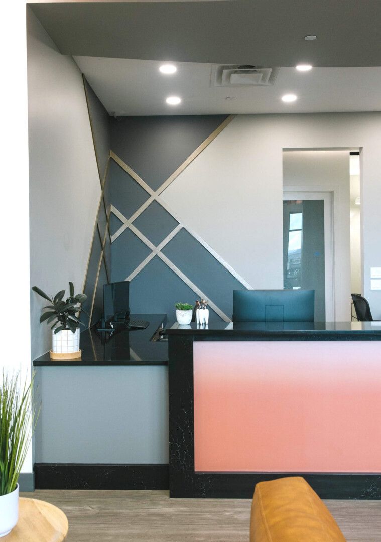 A study in contrast: Wood slats became a recurring design motif, with asymmetrical arrangements and strategically placed sconces creating visual movement while casting dramatic up-and-down lighting throughout the reception and hallway spaces. 