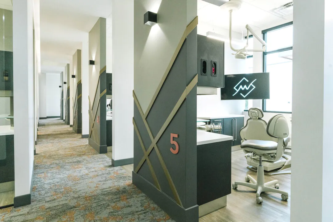 Light and shadow: Ceiling illumination was minimized in favor of linear LEDs and decorative sconces to emphasize depth and texture, allowing natural light to play a larger role and creating a more dramatic transition throughout the office.